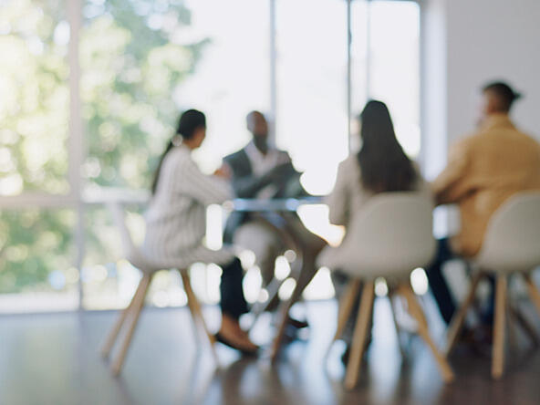 blurred business meeting with four participants